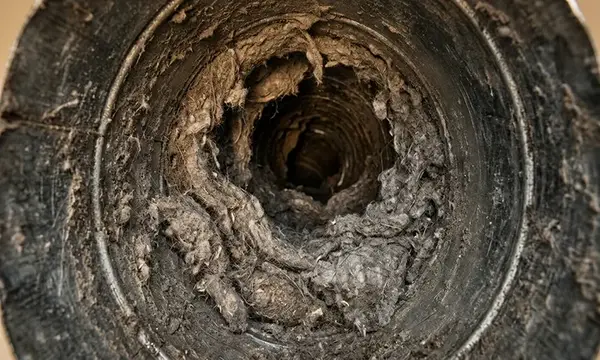 Compacted lint buildup inside a Miami dryer vent pipe — dryer vent fire risk